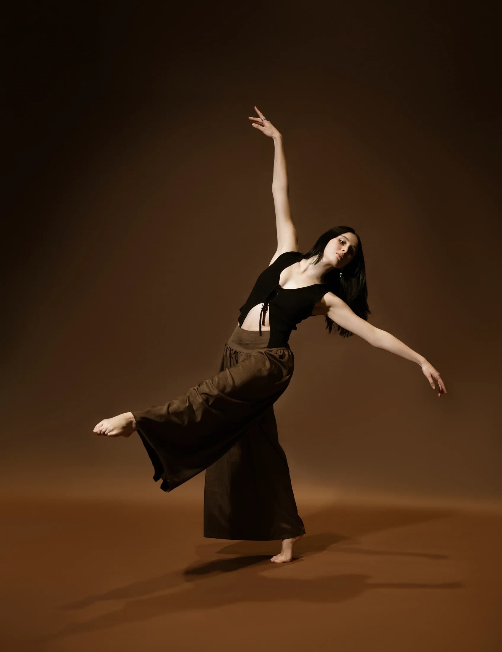 Estafania Forero Yacaman balancing in a warm studio portrait