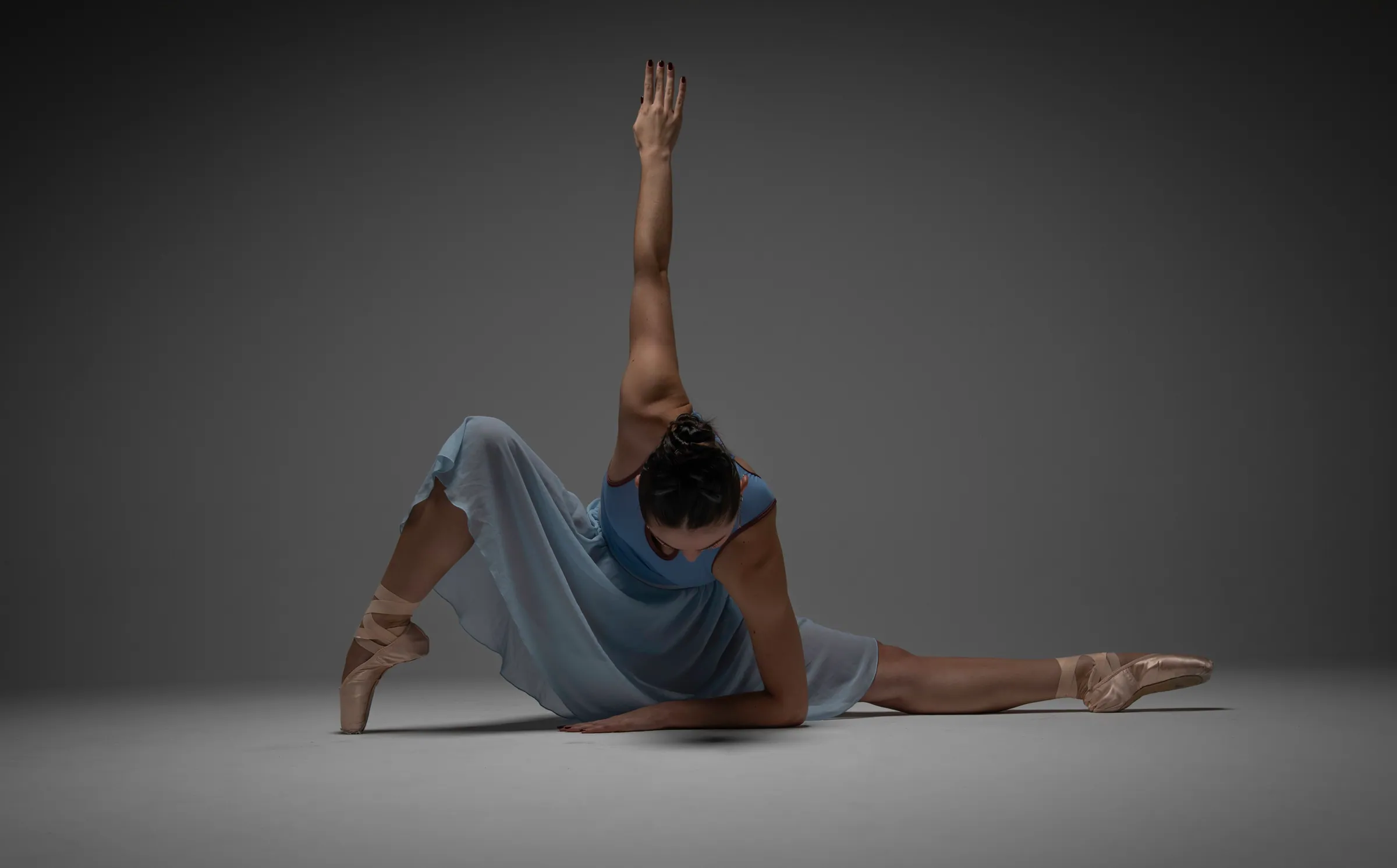 Estefania Forero Yacaman grounded in a blue ballet movement study